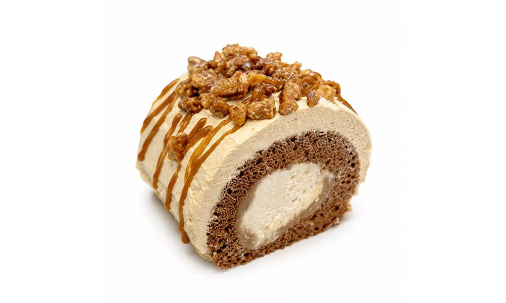 Coffee swiss roll cake with chocolate sponge, cream filling, caramel drizzle and candied nut topping at Sweet Cottage Cafe, a Dessert shop in Lexington